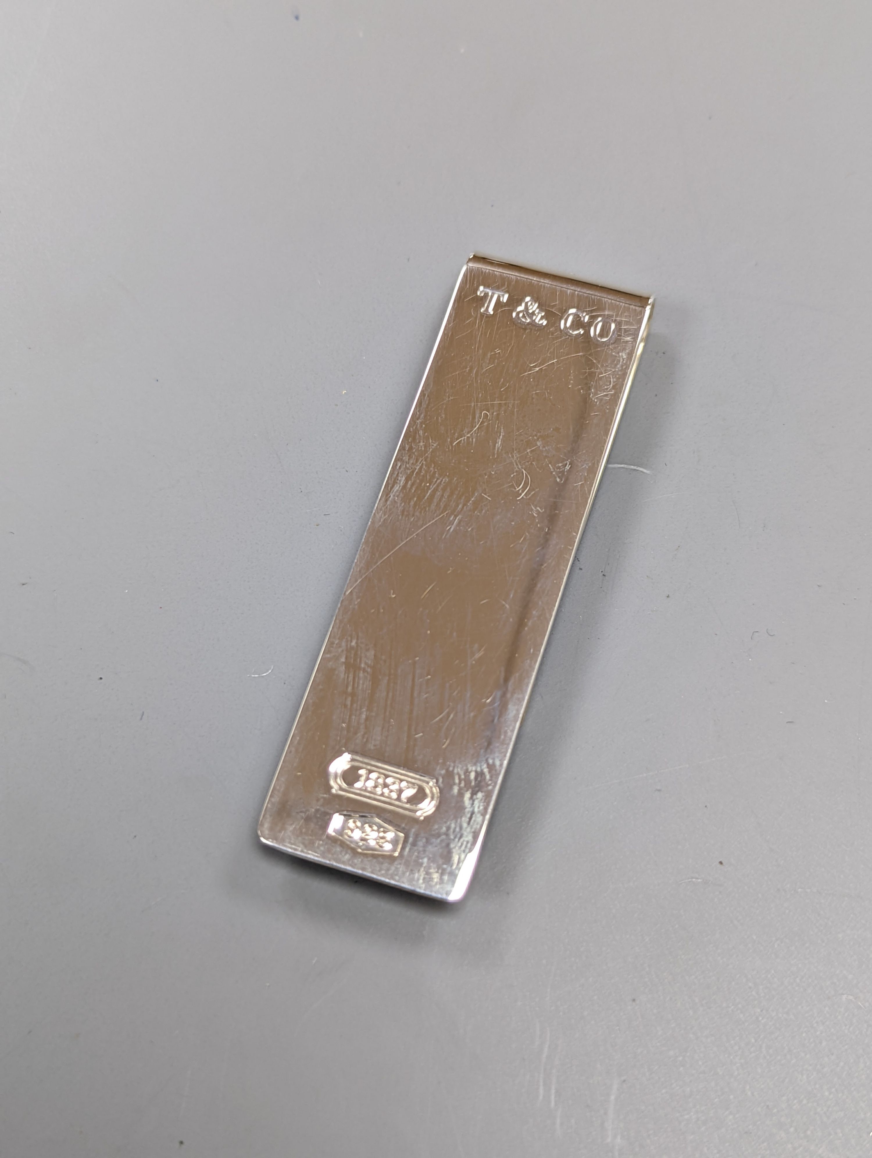A boxed Tiffany & Co sterling silver money clip, and Parker and Sheffer fountain pens.